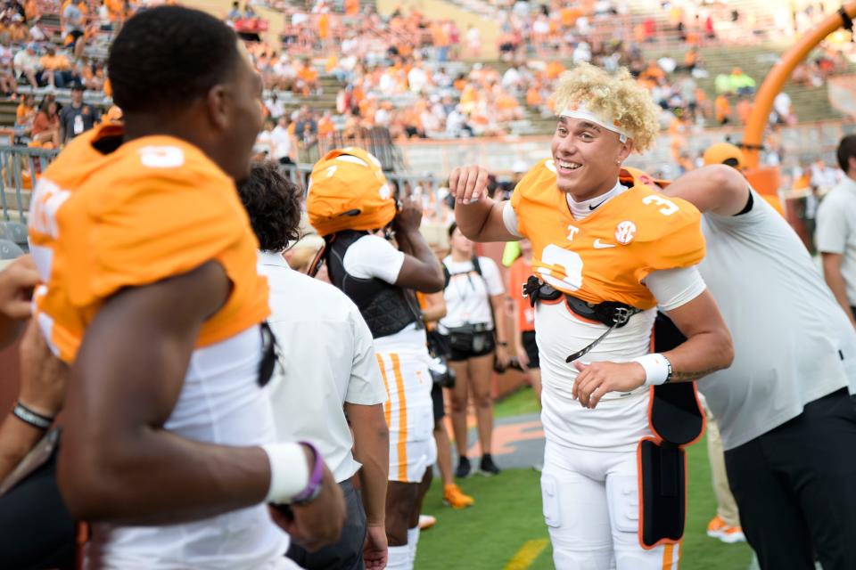 Tennessee quarterback Tayven Jackson (3) chats with Tennessee quarterback Hendon Hooker (5) while putting on their uniforms before the Tennessee football season opener game against Ball State in Knoxville, Tenn. on Thursday, Sept. 1, 2022.