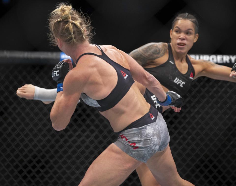 Amanda Nunes, right, knocks out Holly Holm with a kick during the first round of their women's bantamweight mixed martial arts title bout at UFC 239 on Saturday, July 6, 2019, in Las Vegas. Nunes won by knockout. (AP Photo/Eric Jamison)