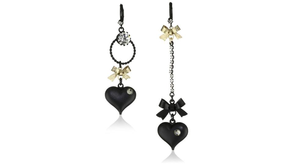 Mismatched earrings create an unexpected fashion twist.