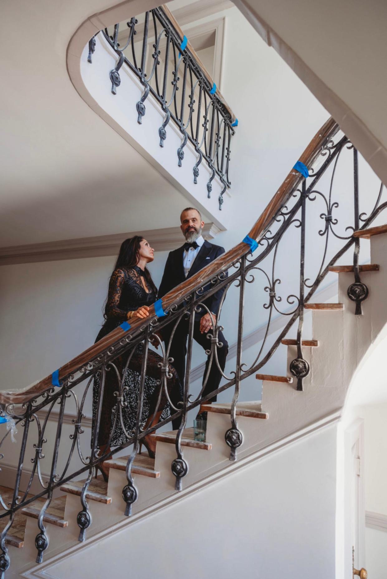 Elizabeth and Jeremy Champion show off the staircase leading up to the second floor of Seven Gables. The historic home is in the process of being renovated.