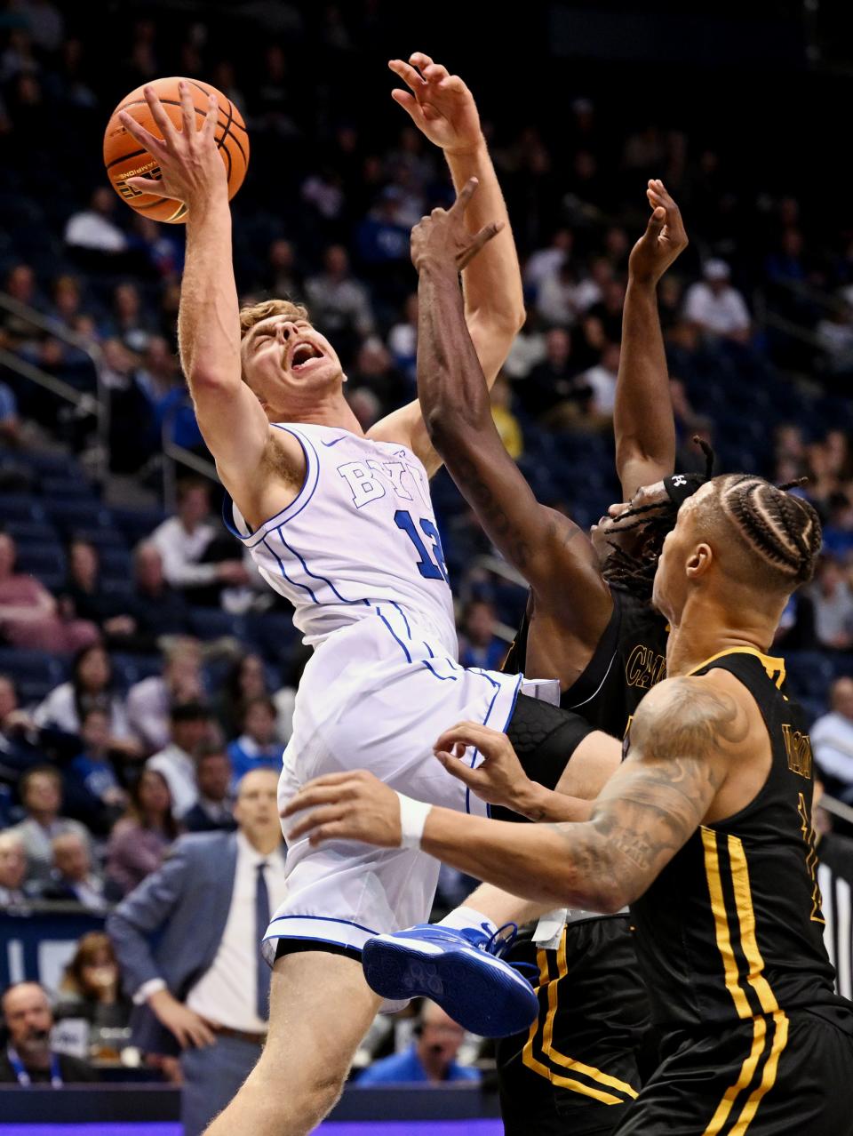 Brigham Young Cougars forward Townsend Tripple (12) is fouled by Southeastern Louisiana Lions forward Dylan Canoville (14) as BYU and SE Louisiana play at the Marriott Center in Provo on Wednesday, Nov. 15, 2023. BYU won 105-48. | Scott G Winterton, Deseret News