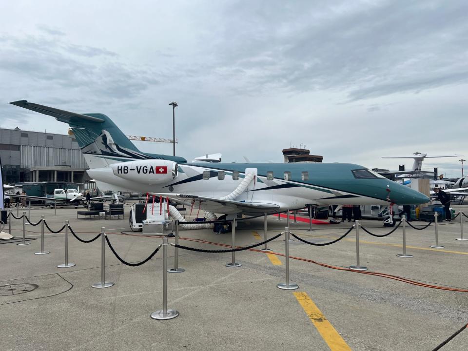 A Pilatus PC-24 in a blue and white livery on display at EBACE 2024 in Geneva.