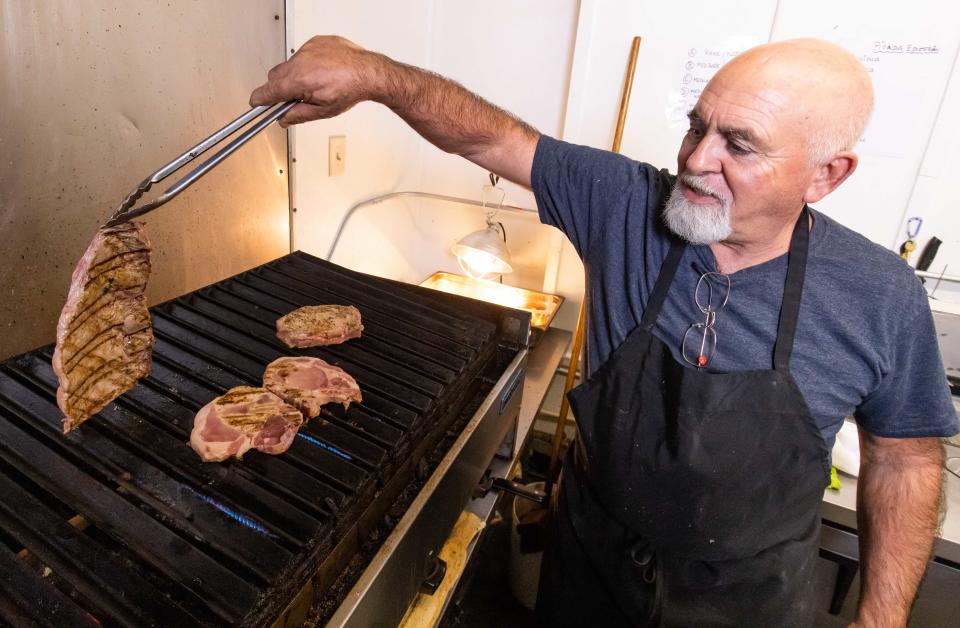 Chef Ruben Eliza grills a top sirloin, pork chops and and a ribeye at the Equestrian Grill