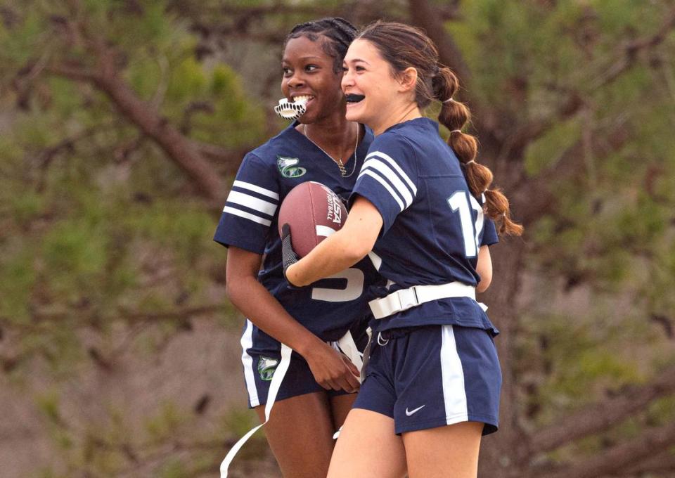 Heritage High School’s Jubilee Okonkwo (5) celebrates with Haylie Betheil (12) after Betheil scored a touchdown during a flag football scrimmage at Heritage High School in Wake Forest, N.C., Wednesday, Jan. 24, 2024.