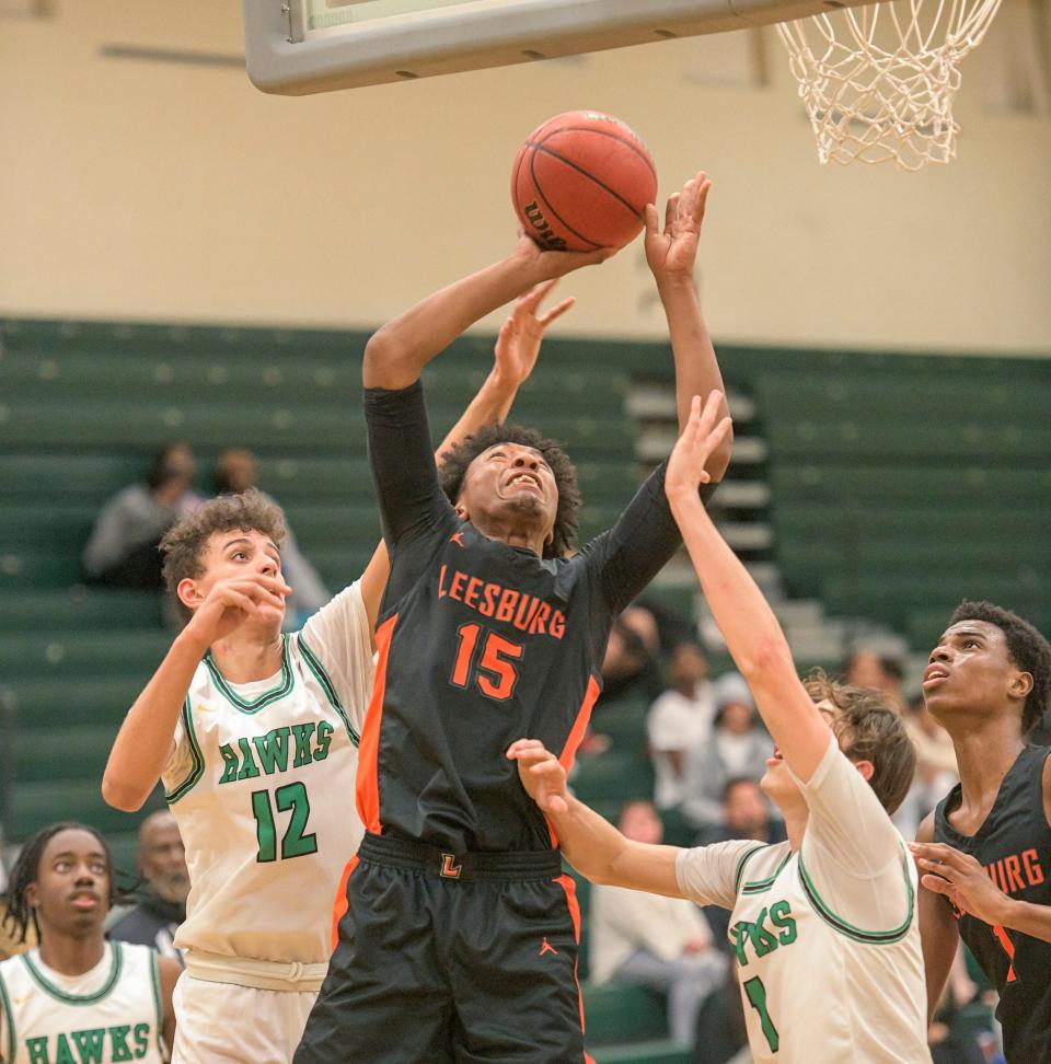 Leesburg's Charles Hill (15) tries to score against Lake Minneola’s Xavier Gordon-Somers (12) and Dylan Diaz (1) in Tuesday's game in Minneola.
