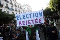 Demonstrators shout slogans during a protest to reject the presidential election in Algiers