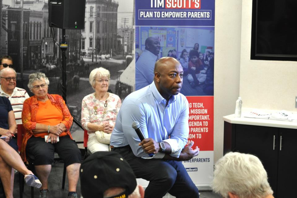 GOP presidential candidate South Carolina Senator Tim Scott listens to a voter asking a question at a town hall in Le Mars, Iowa in the leadup to the January 15, Iowa Caucuses.