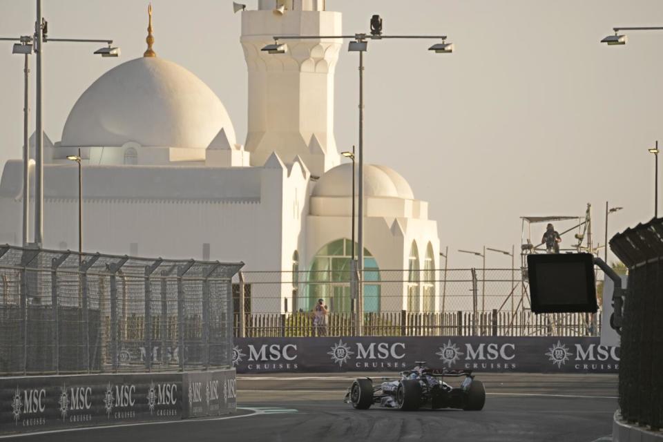 A race car maneuvers around the track in Jeddah, Saudi Arabia.