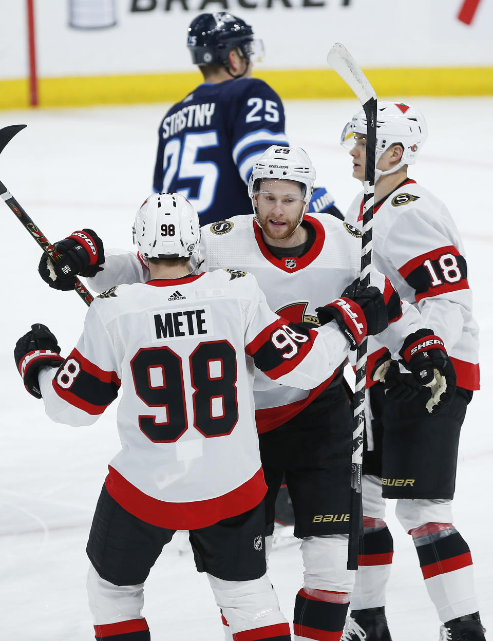 Ottawa Senators' Victor Mete (98) and Connor Brown (28) celebrate Brown's goal against the Winnipeg Jets during first-period NHL hockey game action in Winnipeg, Manitoba, Saturday, May 8, 2021. (John Woods/The Canadian Press via AP)