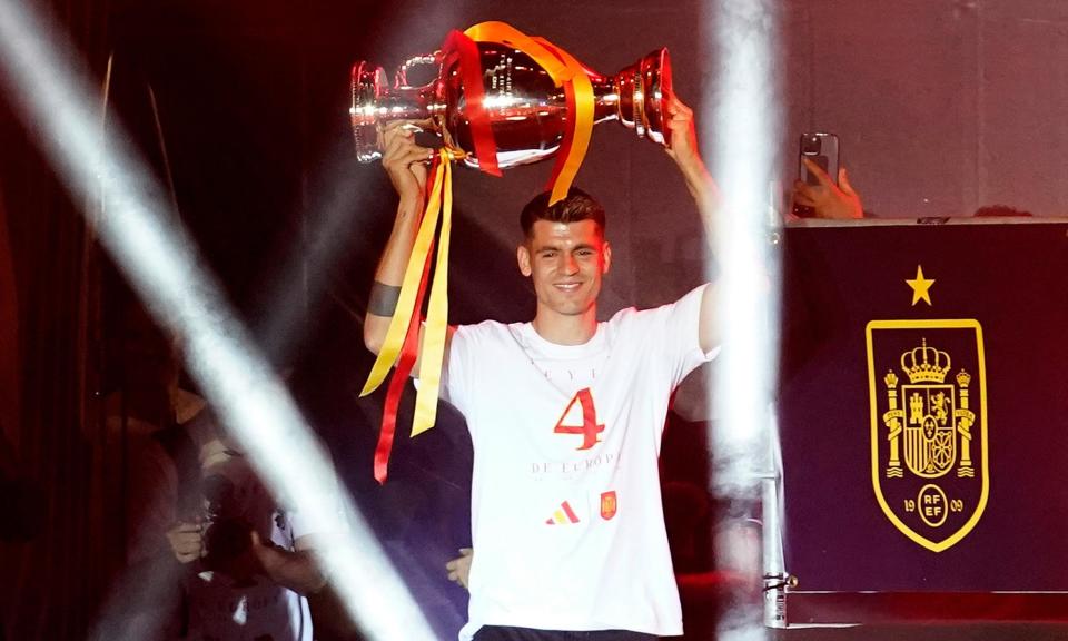 <span>Álvaro Morata carries the European Championship trophy on to the stage at Spain’s victory rally in Madrid.</span><span>Photograph: Andrea Comas/AP</span>