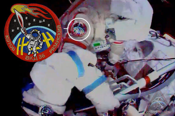 Cosomonaut Oleg Kotov can be seen wearing artist Luc van den Abeelen's Olympic torch patch while holding the real Sochi torch on a spacewalk outside the International Space Station, Nov. 9, 2013.