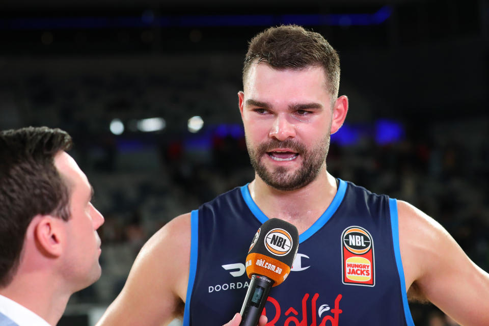 Seen here, Melbourne United star Isaac Humphries speaks to a reporter after an NBL match against the Perth Wildcats in 2022. 