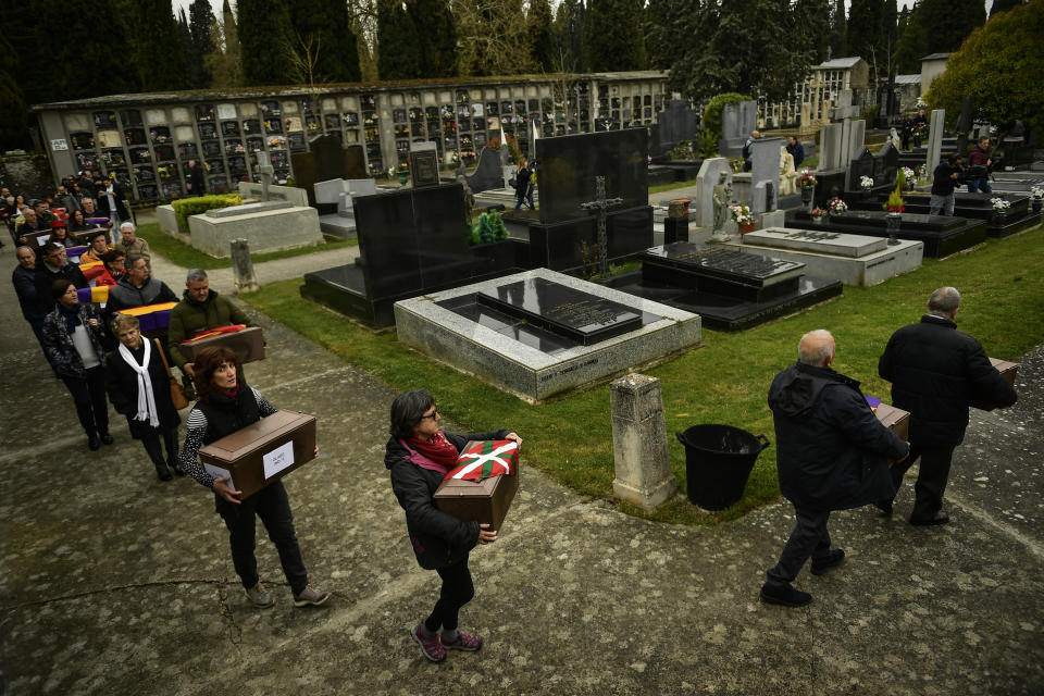 Relatives and friends carry the coffins of some of the 46 coffins of unidentified people killed during the Spanish Civil War, at San Jose cemetery, Pamplona, northern Spain, Monday, April 1, 2019. Marking eight decades since the end of the Spanish Civil War, the remains of 46 unidentified victims of the conflict have been reburied in the northern city of Pamplona. More than half a million people died in the 1936-1939 war between rebel nationalist forces led by Gen. Francisco Franco and defenders of the short-lived Spanish republic. (AP Photo/Alvaro Barrientos)