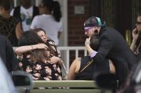 <p>Mourners embrace before the funeral service for Kimberly Morris, one of the victims of the Pulse nightclub mass shooting, in Kissimmee, Fla. <em>(Photo: David Goldman/AP)</em> </p>