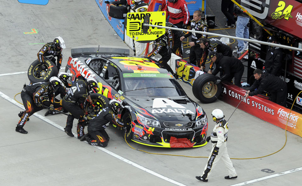 Jeff Gordon make a pit stop during a NASCAR Sprint Cup Series auto race at Martinsville Speedway in Martinsville, Va., Sunday, March 30, 2014. (AP Photo/Mike McCarn)