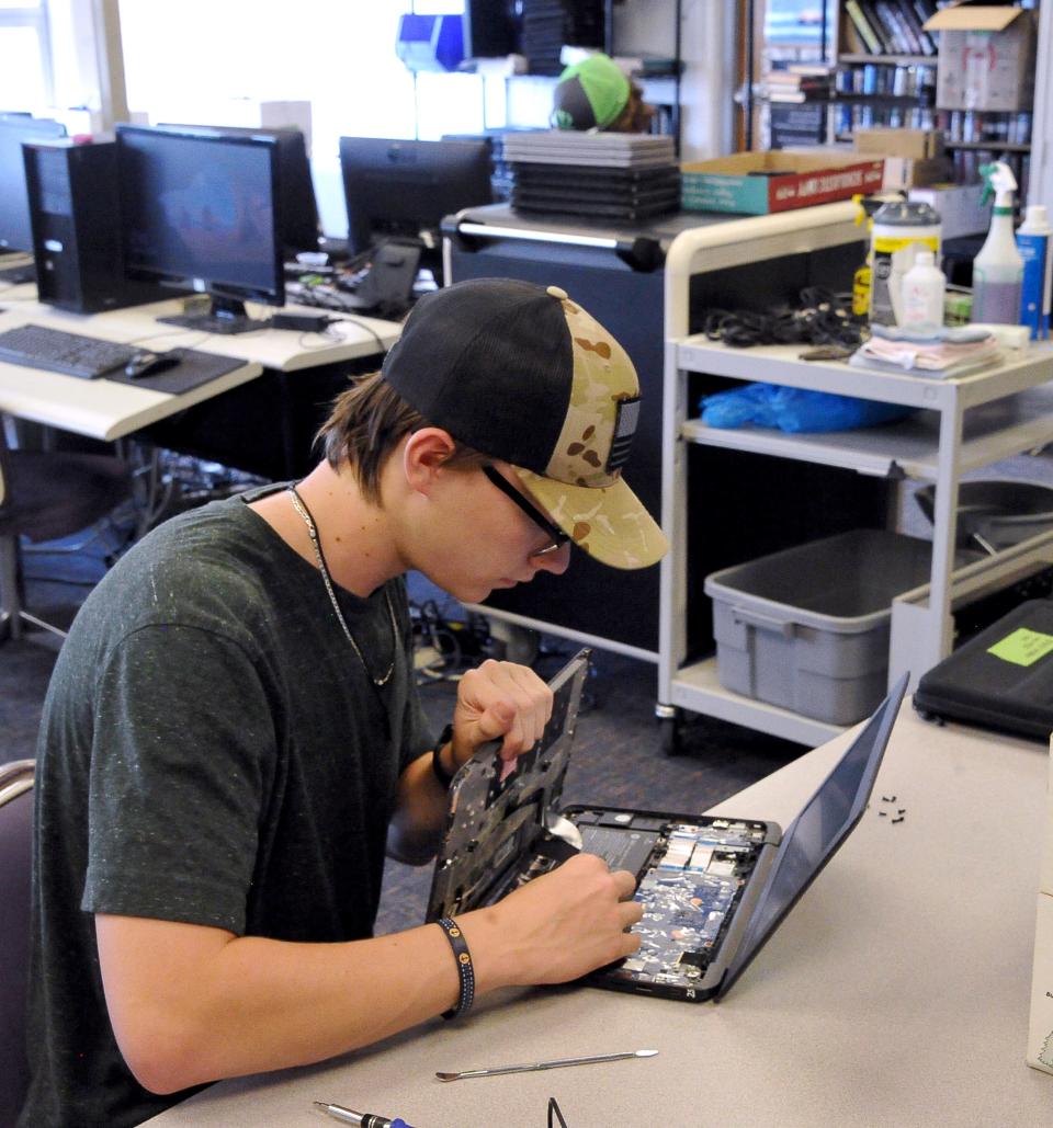 Conner Boggs and Easton Boggs work at Triway repairing Chromebooks for this years students.