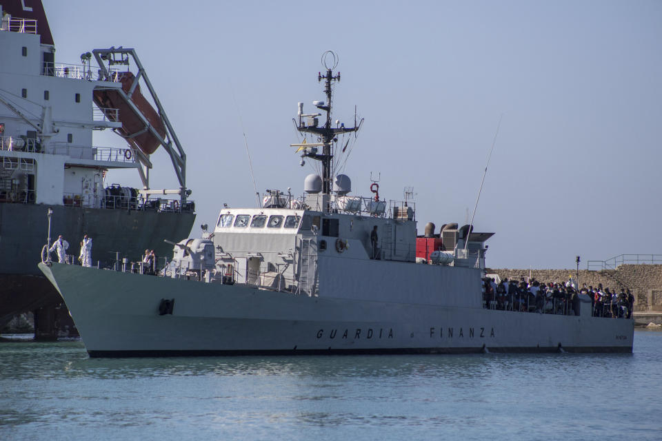 Migrants arrive in Porto Empedocle, Sicily, aboard two military ships after being transferred from the island of Lampedusa, where a number of small boat carrying migrants arrived in the last days, Monday, July 27, 2020. (Fabio Peonia/LaPresse via AP)