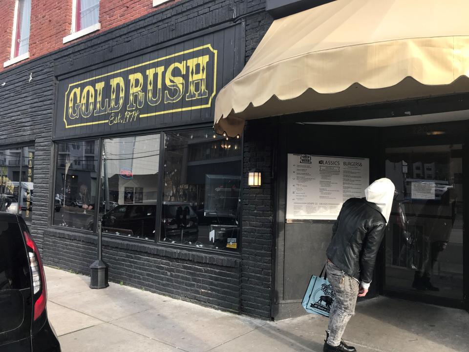 A passerby reads a sign announcing the Gold Rush's closure Feb. 20, 2019 in Elliston Place.