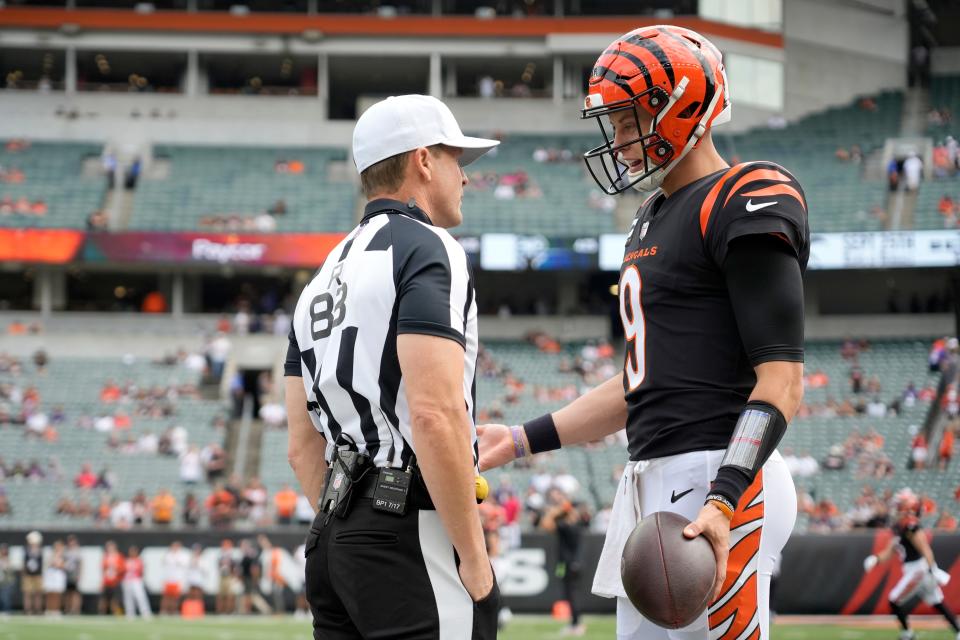 Cincinnati Bengals quarterback Joe Burrow (9) talks with referee Shawn Hochuli (83) prior to a Week 2 NFL football game between the Baltimore Ravens and the Cincinnati Bengals Sunday, Sept. 17, 2023, at Paycor Stadium in Cincinnati.