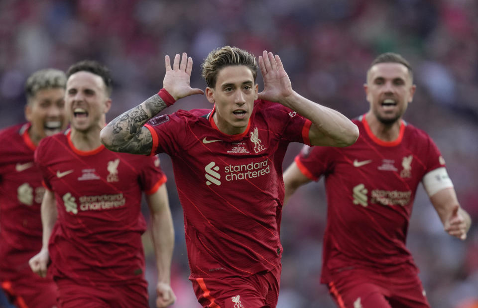 Liverpool's Kostas Tsimikas, center, celebrates with teammates after scoring the winning penalty in a penalty shootout at the end of the English FA Cup final soccer match between Chelsea and Liverpool, at Wembley stadium, in London, Saturday, May 14, 2022. (AP Photo/Kirsty Wigglesworth)