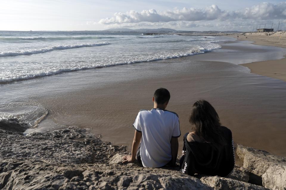 Siblings Sofia Oliveira, 18, and Andre Oliveira, 15, pose for a picture at the beach in Costa da Caparica, south of Lisbon, Wednesday, Sept. 20, 2023. They are two of the six Portuguese children and young adults set to take 32 European governments to court on Wednesday, Sept. 27, for what they say is a failure to adequately address human-caused climate change in a violation of their human rights. (AP Photo/Ana Brigida)