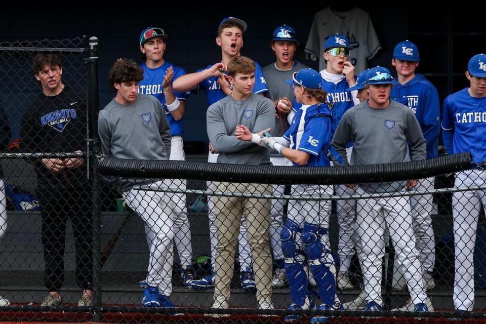 Lexington Catholic’s Owen Jenkins, center, talked with catcher Brady Wasik in the dugout during the Knights’ game against Manual at Lexington Catholic High School on Friday. Jenkins is out due to a minor injury. Silas Walker/swalker@herald-leader.com