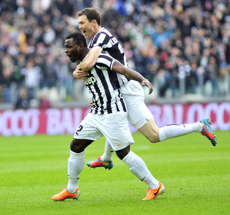 Juventus defender Kwadwo Asamoah, of Ghana, left, celebrates with his teammate Stephan Lichtsteiner of Switzerland, after he scored during a Serie A soccer match between Juventus and Chievo Verona, at the Juventus stadium, in Turin, Italy, Sunday, Feb. 16, 2014. (AP Photo/Massimo Pinca)