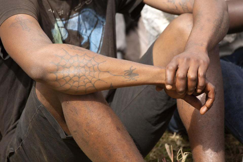 Prisoners are briefed about the dangers of the coronavirus following their release from Chikurubi prison on the outskirts of Harare, Saturday, April 17, 2021. Zimbabwe began the release of about 3,000 prisoners under a presidential amnesty aimed at easing congestion and minimizing the threat of COVID-19 across the country's overcrowded jails. (AP Photo/Tsvangirayi Mukwazhi)