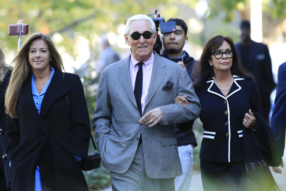 Roger Stone, center, with his wife, Nydia Stone, right, arrive at the federal court in Washington, Tuesday, Nov. 5, 2019. Stone, a longtime Republican provocateur and former confidant of President Donald Trump, goes on trial over charges related to his alleged efforts to exploit the Russian-hacked Hillary Clinton emails for political gain. (AP Photo/Manuel Balce Ceneta)