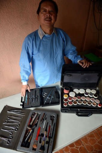 Filipino mortician Frank Malabed with the equipment he uses for embalming. "I make people beautiful even in death," the bespectacled 62-year-old grandfather with a sparse walrus moustache told AFP from his Manila home office