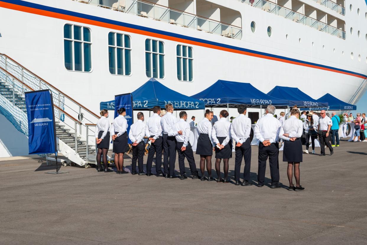 GIUDECCA, VENICE, ITALY - SEPT 2 2022: Crew in a row during welcome reception of the most luxurious cruise ship MS Europa 2, Hapag-LLoyd Cruises. Giudecca, Venice in Italy.