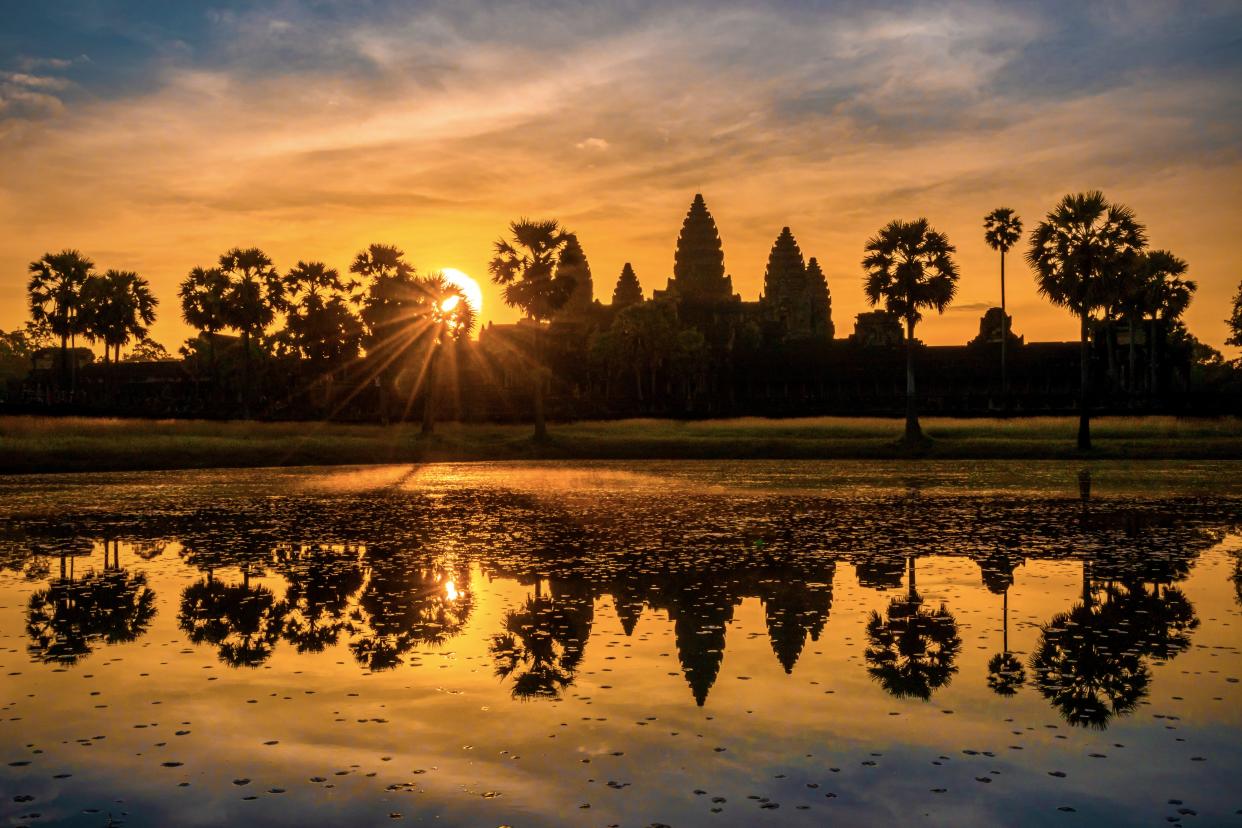 The best thing to do in Cambodia is to visit Angkor Wat! Scenic View of Angkor Wat against Sky During Sunrise, Angkor Wat, located in Siem Reap, Cambodia, is the world's largest religious monument and an iconic symbol of the country. It became a Buddhist temple toward the end of the 12th century despite the orignal intention was built as a Hindu temple of god Vishnu for the Khmer Empire. Siem Reap Province, Cambodia, Asia. June, 22, 2022