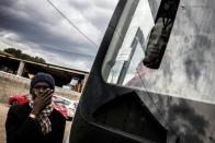 A migrant arrives by bus from the Calais Jungle, on October 24, 2016 at the Montlaville castle in Chardonnay