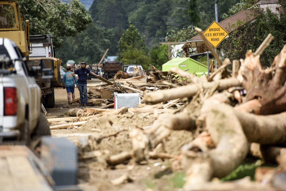 People navigate through debris after the Rocky Broad River flowed into Lake Lure and flooded the city with debris following heavy rains from Hurricane Helene on September 28, 2024 in Lake Lure, NC (Melissa Sue Gerrits / Getty Images)