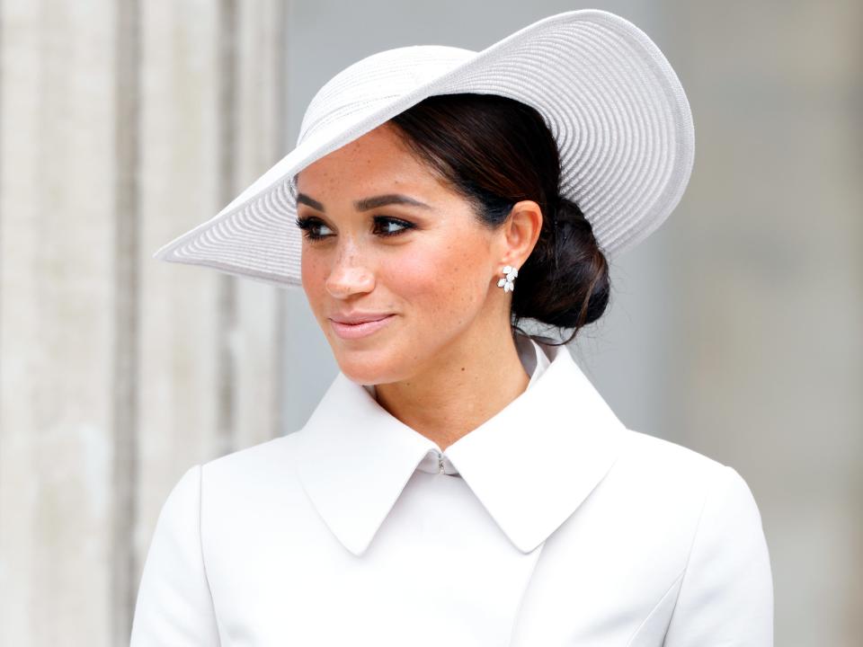 Meghan Markle in a white jacket and hat