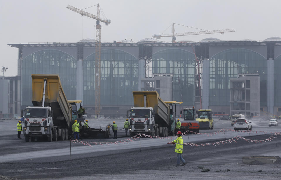 FILE-In this April 13, 2018, file photo, construction workers at Istanbul's third international airport take a break. The first phase of the airport, one of Turkey's President Recep Tayyip Erdogan's major construction projects, is scheduled to be inaugurated on Oct. 29 when Turkey celebrates Republic Day. The massive project, has been mired in controversy over worker's rights and environmental concerns amid a weakening economy. (AP Photo/Lefteris Pitarakis, File)