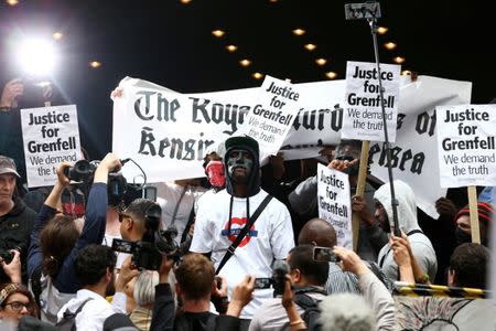 Demonstrators protest against the Grenfell Tower fire outside a Kensington and Chelsea Council meeting at Kensington Town Hall in London, Britain July 19, 2017. REUTERS/Neil Hall