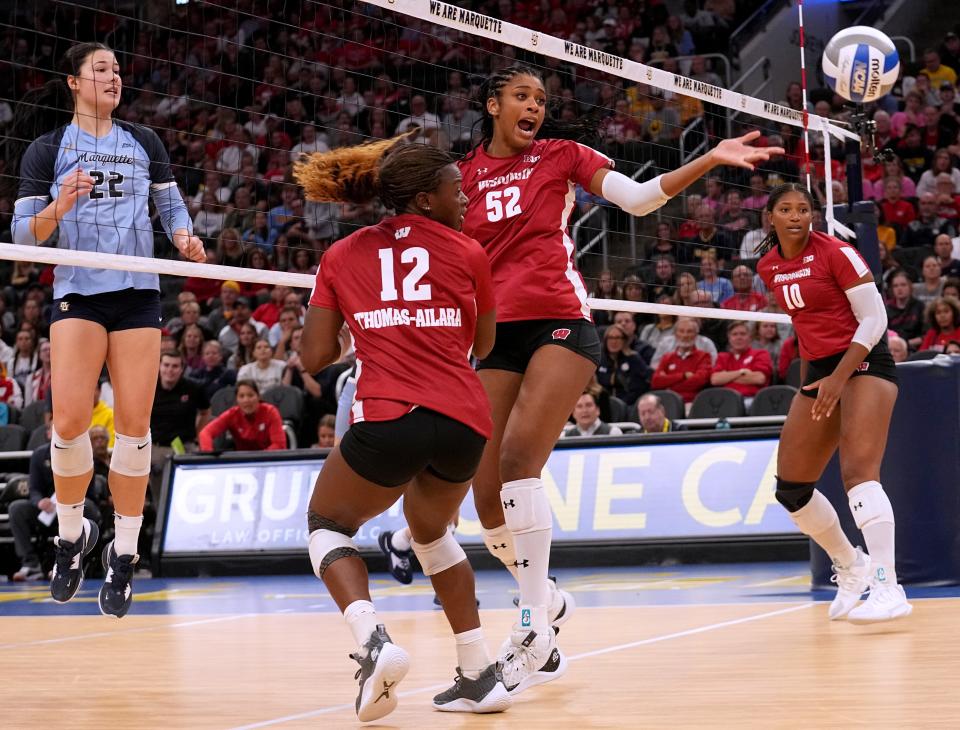 A shot by Marquette middle blocker Hattie Bray (22) gets past Wisconsin middle blocker Carter Booth (52) during their volleyball match Wednesday, September 13, 2023 at Fiserv Forum in Milwaukee, Wis. Official attendance was 17,037 making it the largest indoor regular-season crowd for a volleyball match in NCAA history and the largest crowd to see a women’s sporting event in Wisconsin history.