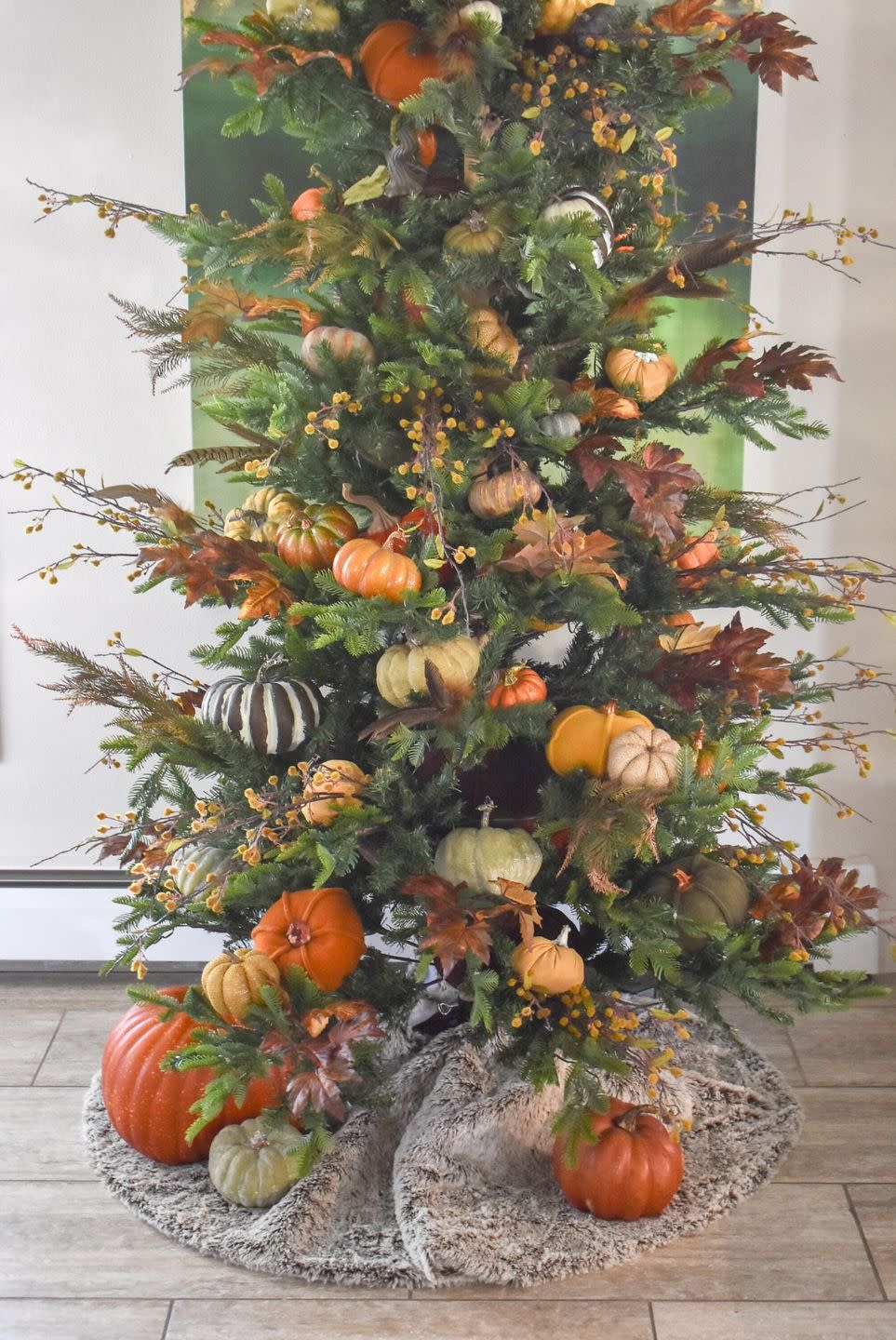 a tree with pumpkins and other vegetables on it