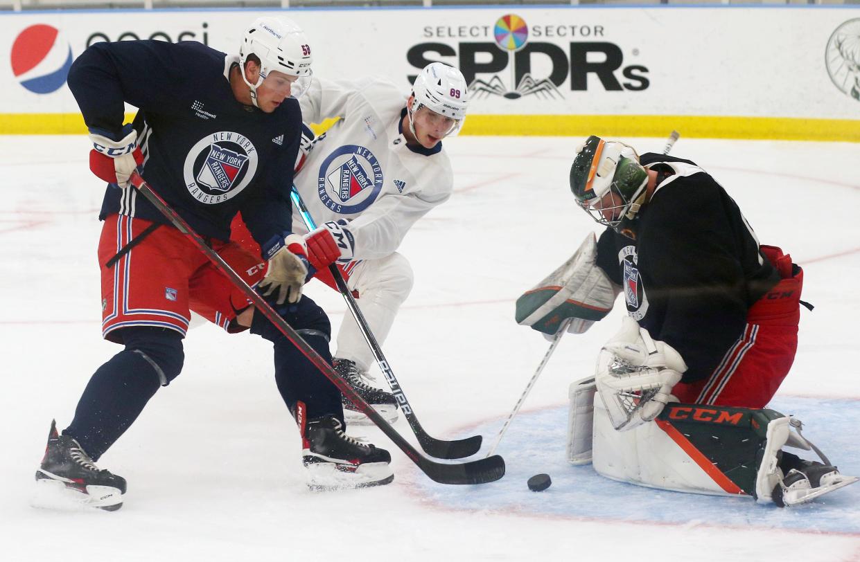 Goalie Olof Lindbom stops a shot as Brandon Scanlin (58) plays defense during Rangers Prospect Development Camp at the MSG Training Center in Tarrytown July 12, 2022.