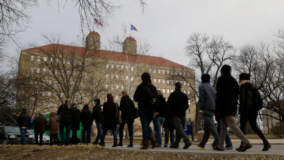 University of Kansas students and faculty walk past Fraser Hall on campus. The Kansas Board of Regents recently asked universities to list courses that include Critical Race Theory.