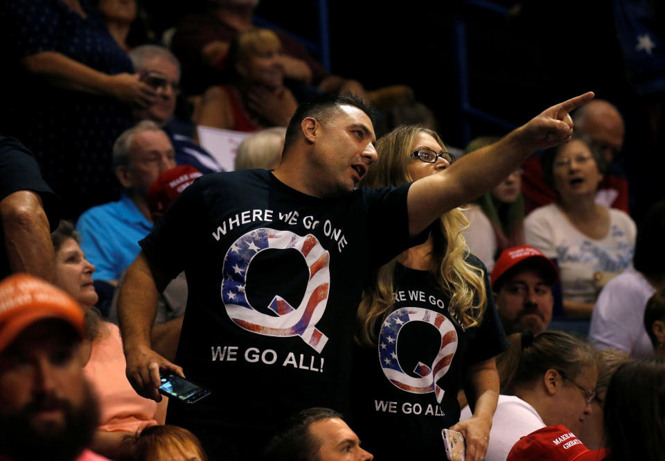 Supporters wearing shirts with the QAnon logo, chat before U.S. President Donald Trump takes the stage during his Make America Great Again rally in Wilkes-Barre, PA. REUTERS/Leah Millis