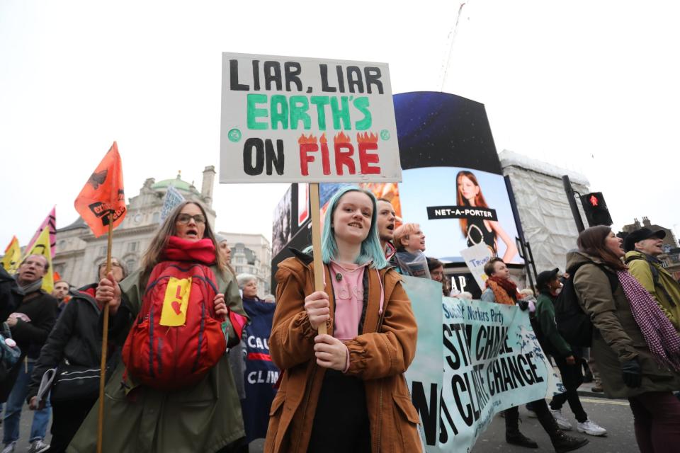 Protesters during an Extinction Rebellion (XR) march through Piccadilly Circus to Parliament Square in February (PA)