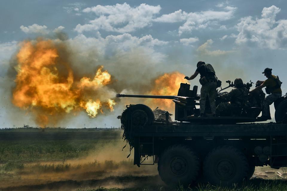 Ukrainian soldiers fire a cannon near the eastern city of Bakhmut in the Donetsk region of Ukraine on May 15, 2023.