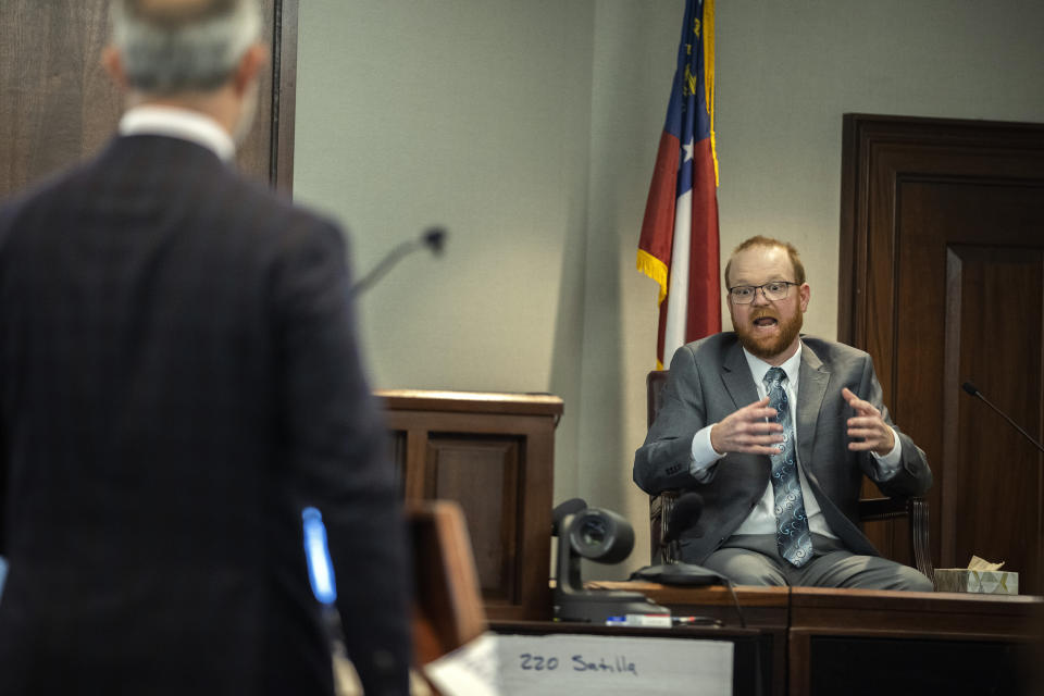 Travis McMichael speaks from the witness stand during the trial of he, his father Greg McMichael and neighbor William "Roddie" Bryan in the Glynn County Courthouse, Wednesday, Nov. 17, 2021, in Brunswick, Ga. The three are charged with the February 2020 slaying of 25-year-old Ahmaud Arbery. (AP Photo/Stephen B. Morton, Pool)