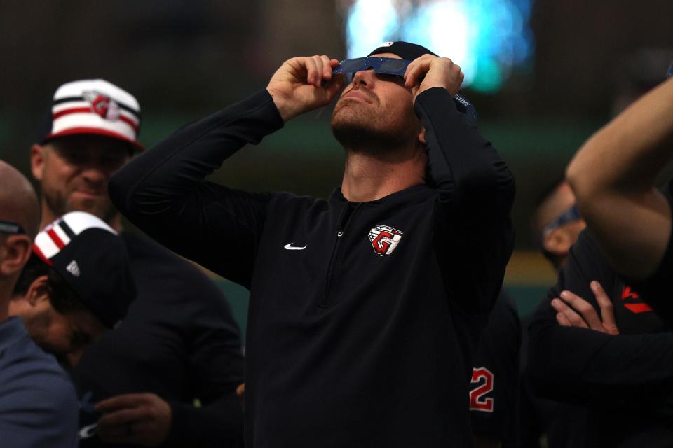 Shane Bieber #57 of the Cleveland Guardians looks up at the total solar eclipse before the home opener against the Chicago White Sox at Progressive Field on April 08, 2024 in Cleveland, Ohio.