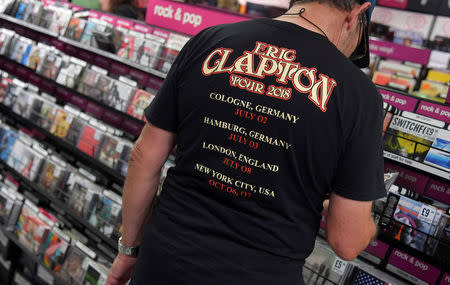 A shopper wearing a music tour t-shirt browses record albums at an HMV music store in London, Britain, July 20, 2018. REUTERS/Toby Melville