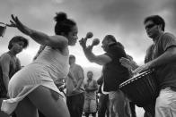 <p>A young woman dances to the entrancing rhythms at the Venice Beach Drum Circle, as the sun sets over the ocean on a warm summer evening. (© Dotan Saguy) </p>