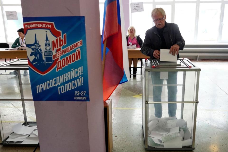 <div class="inline-image__caption"><p>A man casts his ballot for a referendum at a polling station in Mariupol on Sept. 27, 2022.</p></div> <div class="inline-image__credit">AFP via Getty</div>