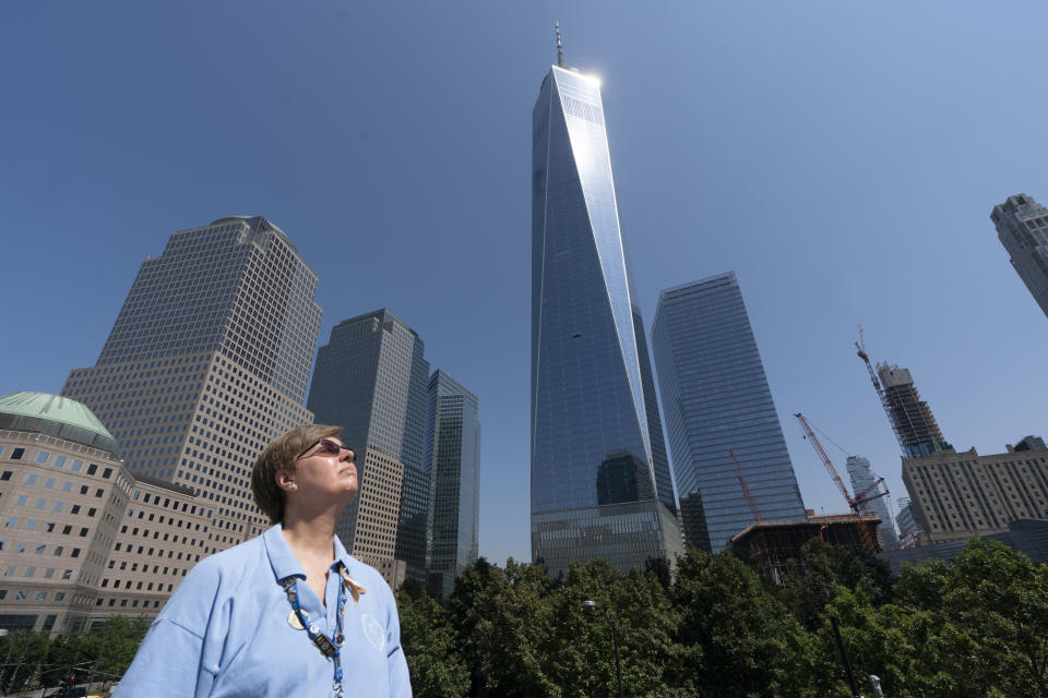 Désirée Bouchat poses for a photo at the World Trade Center, Friday, Aug. 6, 2021, in New York. At first, people figured the plane crash at the north tower was accidental. There was no immediate evacuation order for the south tower. But James Patrick Berger ushered Bouchat and other Aon Corp. colleagues to the elevators, then turned back to check for more people. (AP Photo/Mark Lennihan)